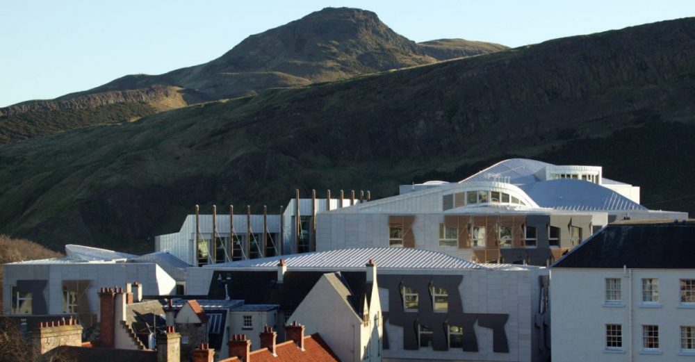 Scottish Parliament building with Arthurs Seat in the background
