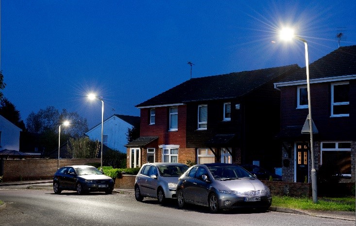 Cars parked on lit residential street