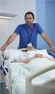 Hospital porter moving patient in hospital bed